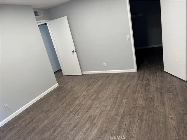 a view of a room with wooden floor