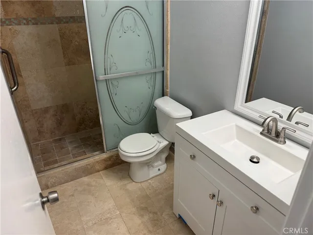 a bathroom with a toilet a sink and a shower