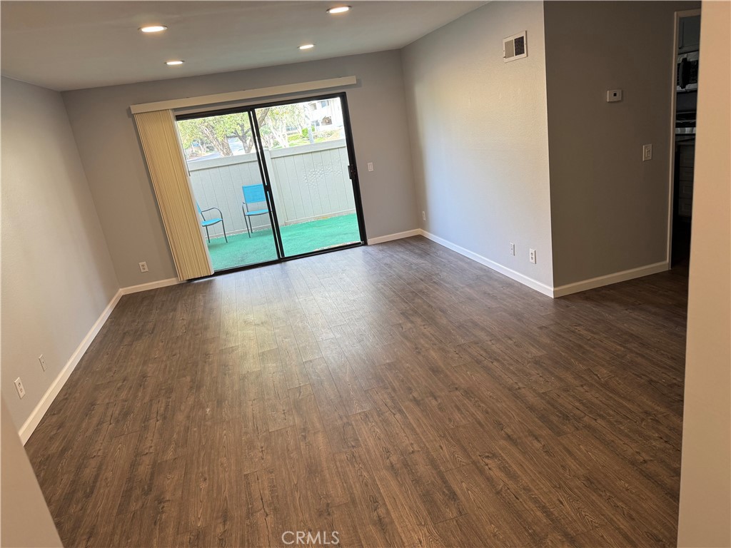 13602 La Jolla Circle, Unit B La Mirada, CA 90638 - Photo 7 of 27 an empty room with wooden floor and windows