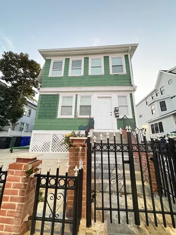 a front view of a house with glass top table and chairs