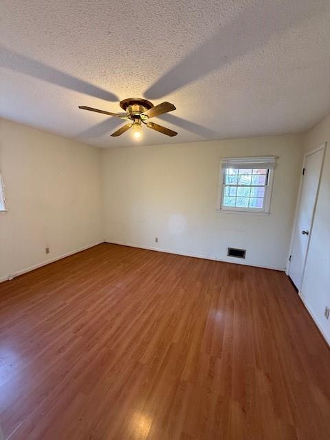 408 Peters Street Calhoun, GA 30701 - Photo 8 of 10 an empty room with wooden floor fan and windows
