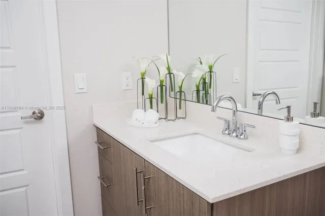 a bathroom with double vanity sink and a mirror