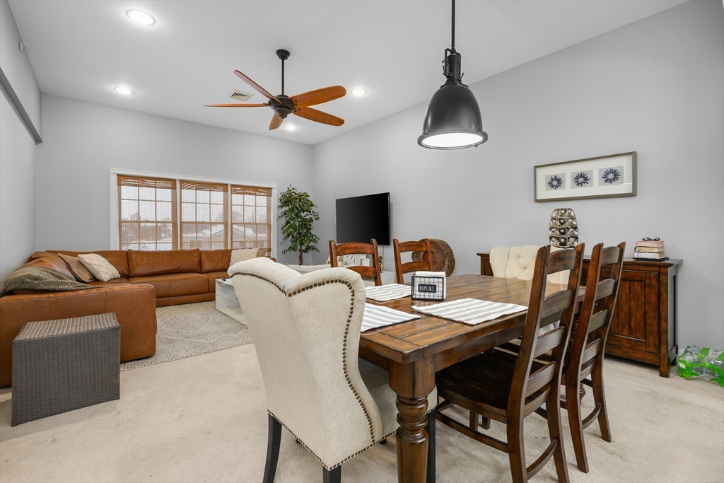 68 Center Street, Unit 13 Barnstable, MA 02601 - Photo 5 of 29 a view of a livingroom and a dining room with furniture wooden floor and a chandelier