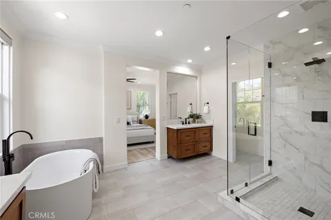 a large spacious bathroom with a tub sink shower and mirror