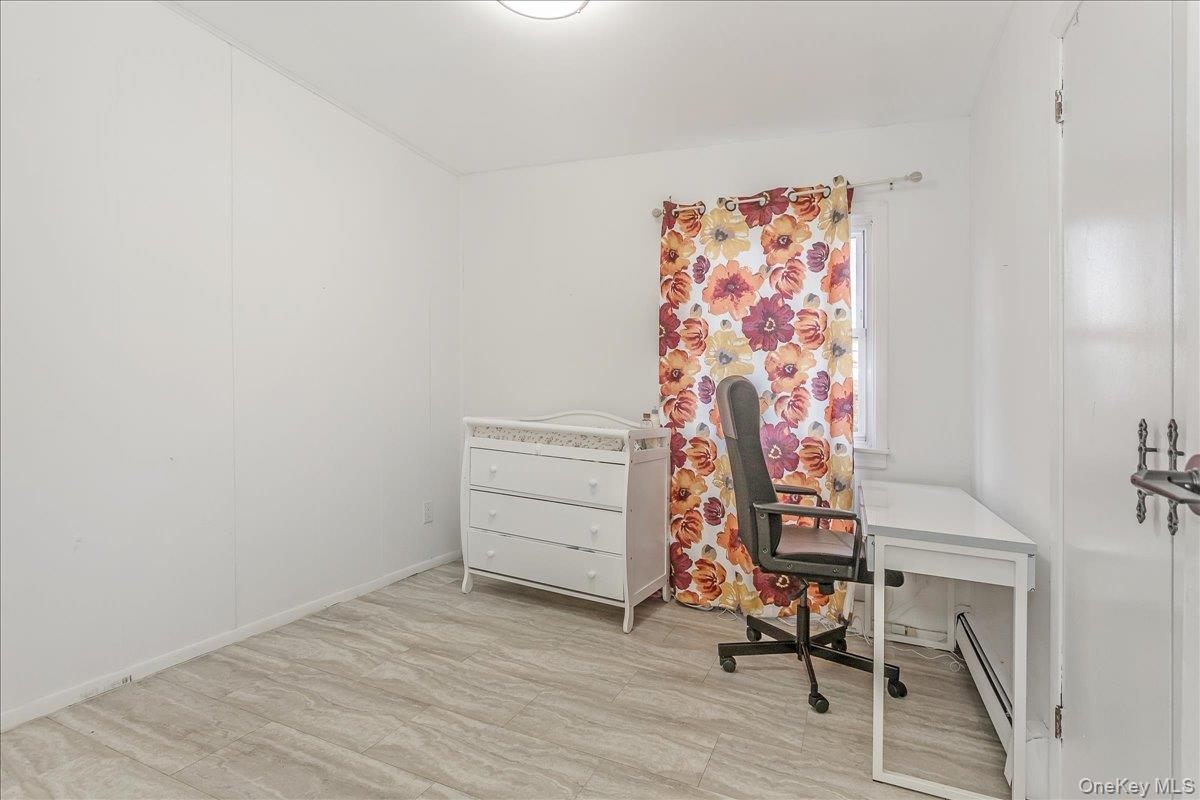 93 Searingtown Road Albertson, NY 11507 - Photo 12 of 24 Office space featuring light wood finished floors and a baseboard radiator
