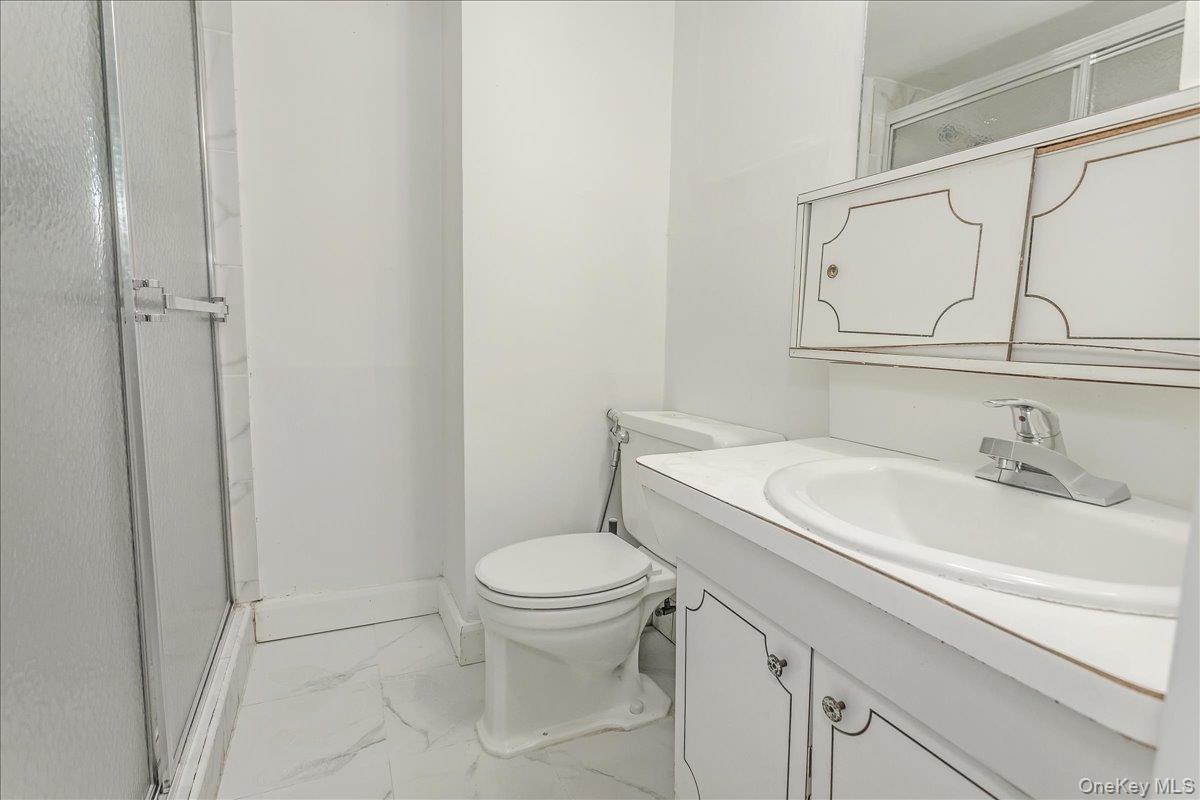 93 Searingtown Road Albertson, NY 11507 - Photo 19 of 24 Bathroom with vanity, a stall shower, and light marble finish flooring