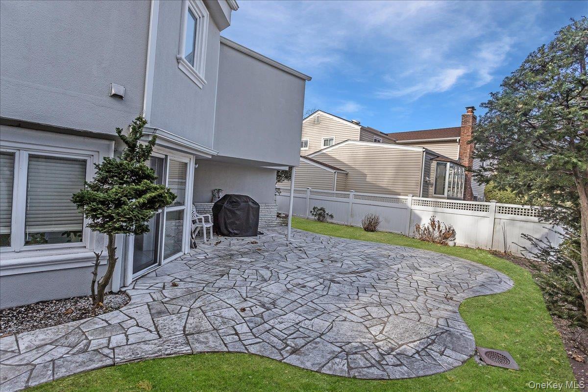 93 Searingtown Road Albertson, NY 11507 - Photo 22 of 24 Fenced backyard with a patio and area for grilling
