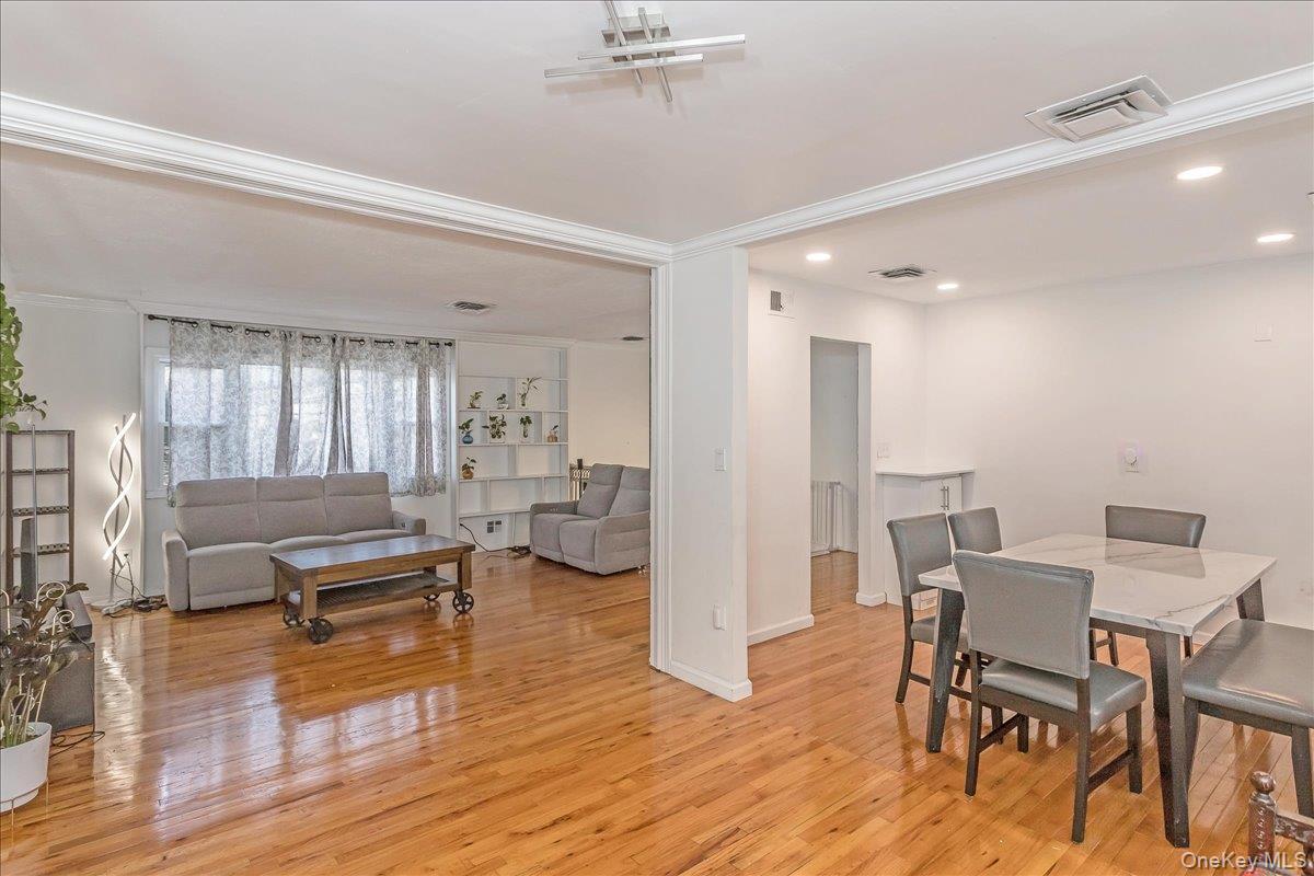93 Searingtown Road Albertson, NY 11507 - Photo 24 of 24 Dining area featuring ornamental molding and light wood-type flooring