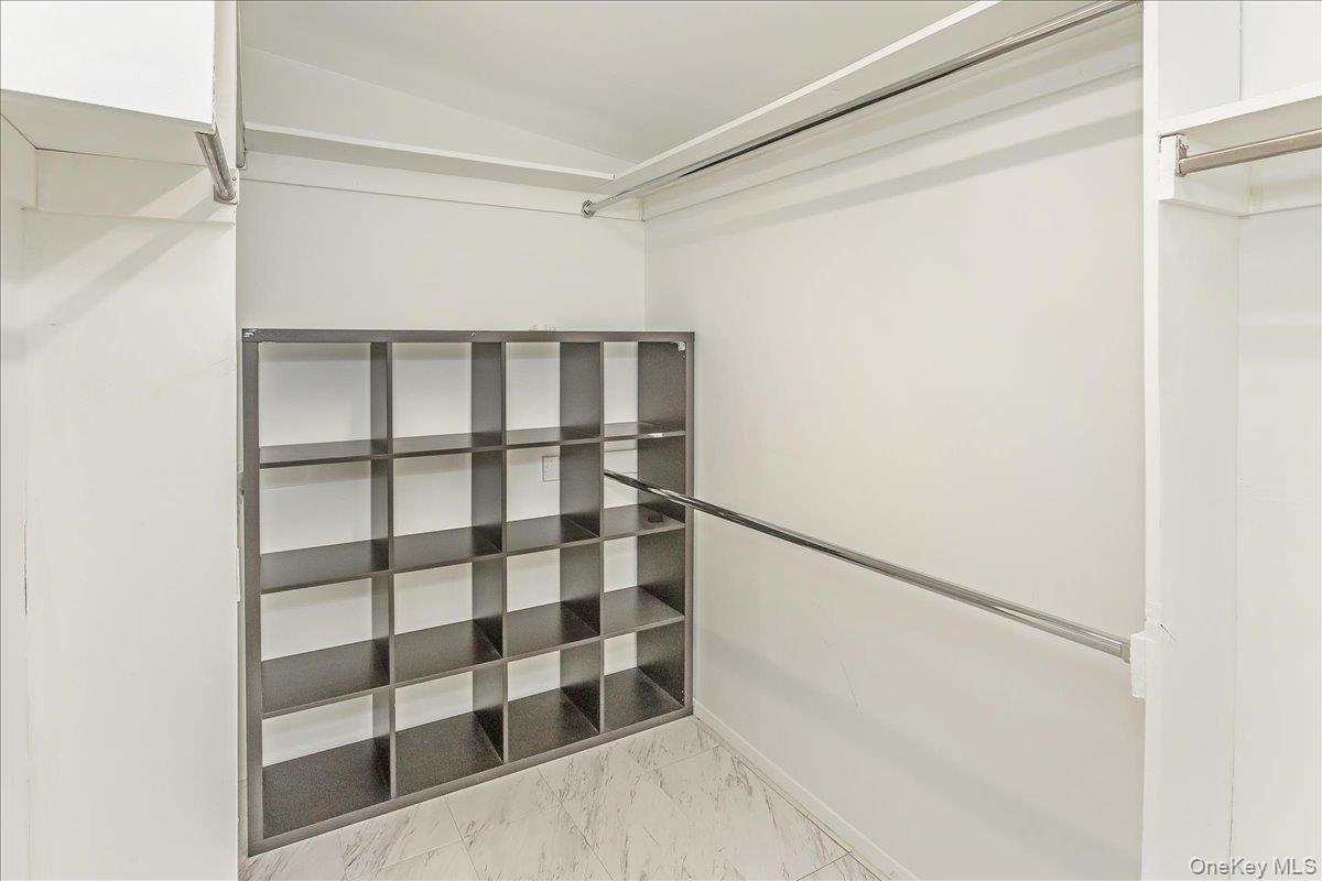 93 Searingtown Road Albertson, NY 11507 - Photo 10 of 24 Spacious closet featuring lofted ceiling and light marble finish floors
