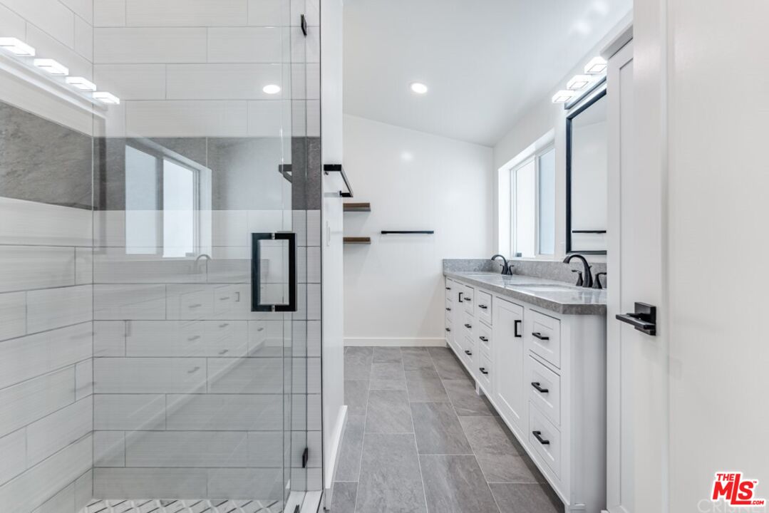 1177 Aztec Topanga, CA 90290 - Photo 13 of 43 a bathroom with granite countertop shower two sinks and a shower