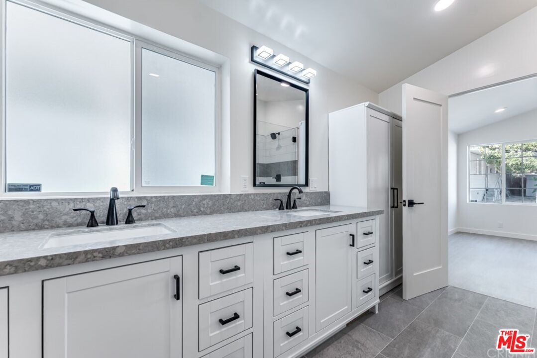 1177 Aztec Topanga, CA 90290 - Photo 15 of 43 a bathroom with double sink and a mirror