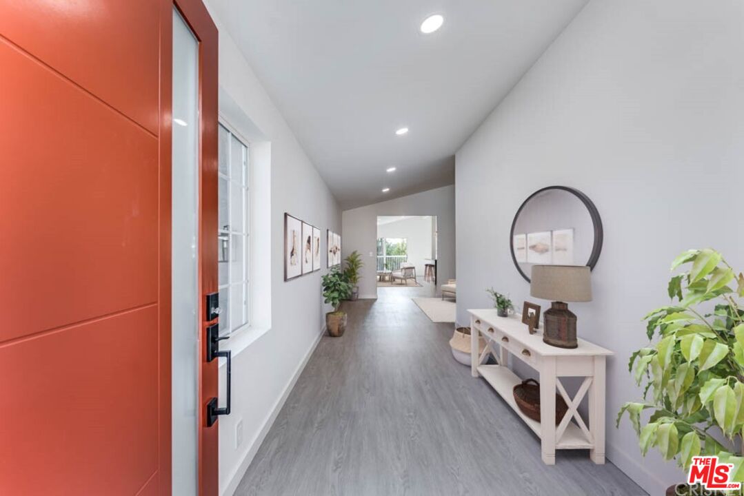 1177 Aztec Topanga, CA 90290 - Photo 2 of 43 an entryway with wooden floor and a chandelier