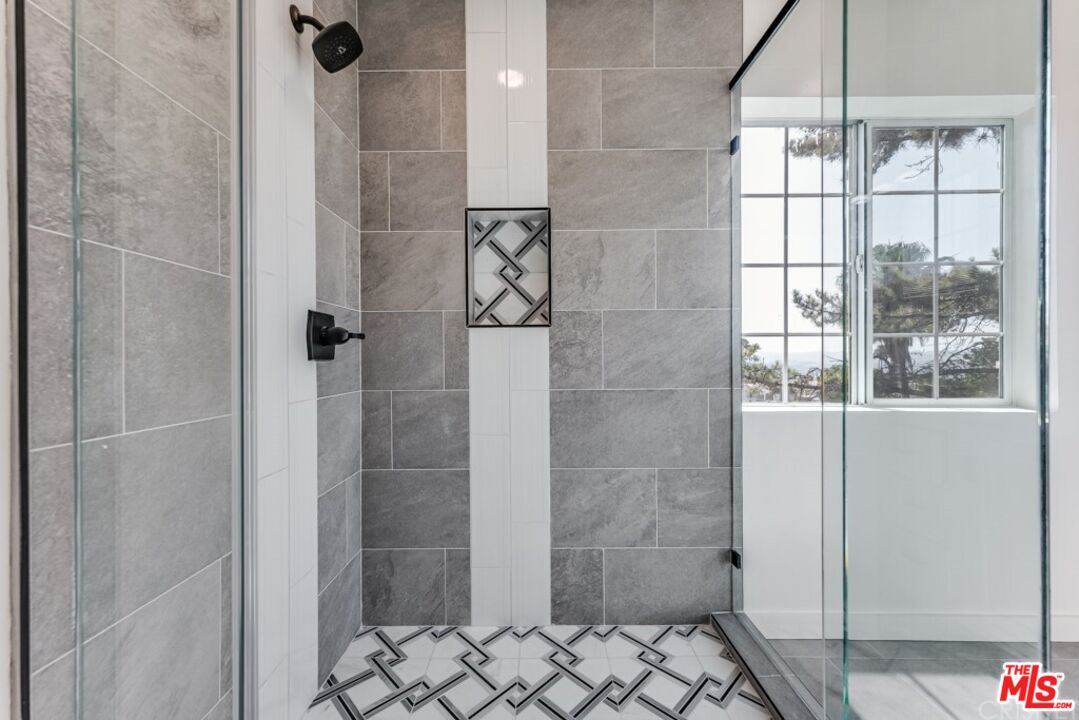 1177 Aztec Topanga, CA 90290 - Photo 22 of 43 a bathroom with a glass shower door