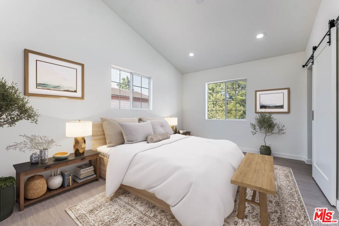 1177 Aztec Topanga, CA 90290 - Photo 27 of 43 a bedroom with a bed couch and window