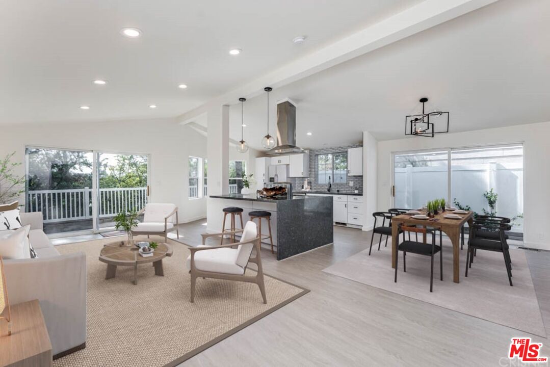 1177 Aztec Topanga, CA 90290 - Photo 3 of 43 a living room with furniture a large window and a table