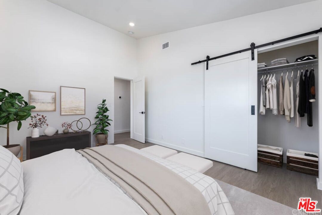 1177 Aztec Topanga, CA 90290 - Photo 31 of 43 a bedroom with a bed and a chair