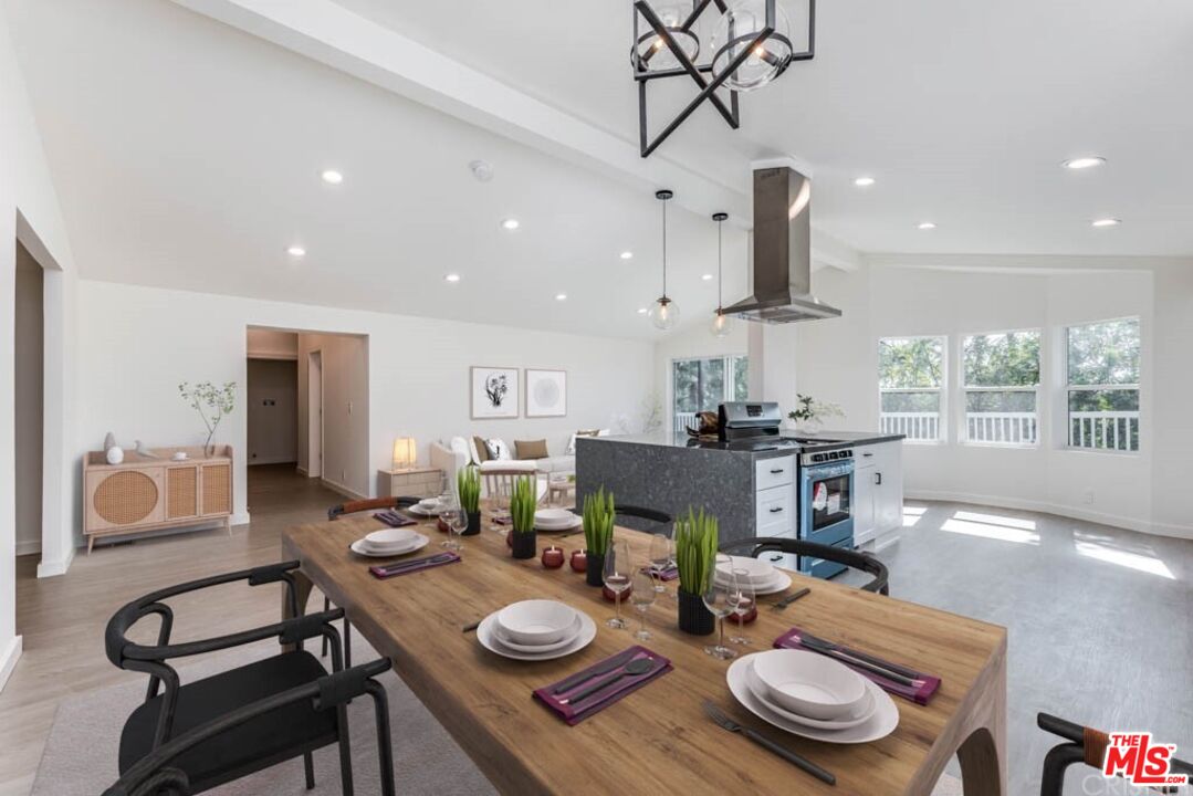 1177 Aztec Topanga, CA 90290 - Photo 4 of 43 a view of a dining room with furniture a chandelier and wooden floor