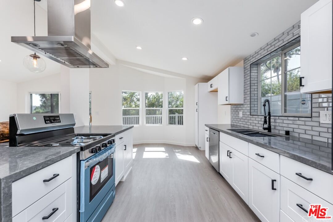 1177 Aztec Topanga, CA 90290 - Photo 5 of 43 a kitchen with stainless steel appliances granite countertop a stove and a sink