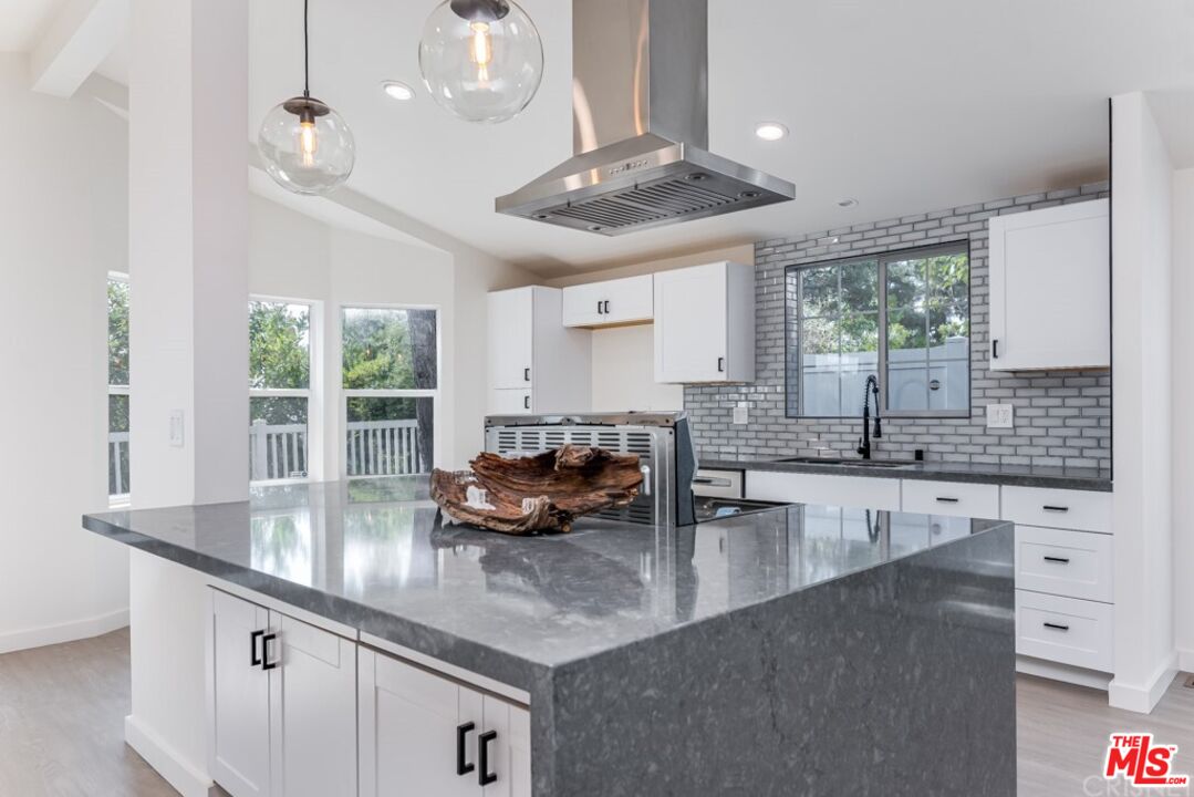 1177 Aztec Topanga, CA 90290 - Photo 6 of 43 a kitchen with granite countertop a sink a counter top space appliances and cabinets