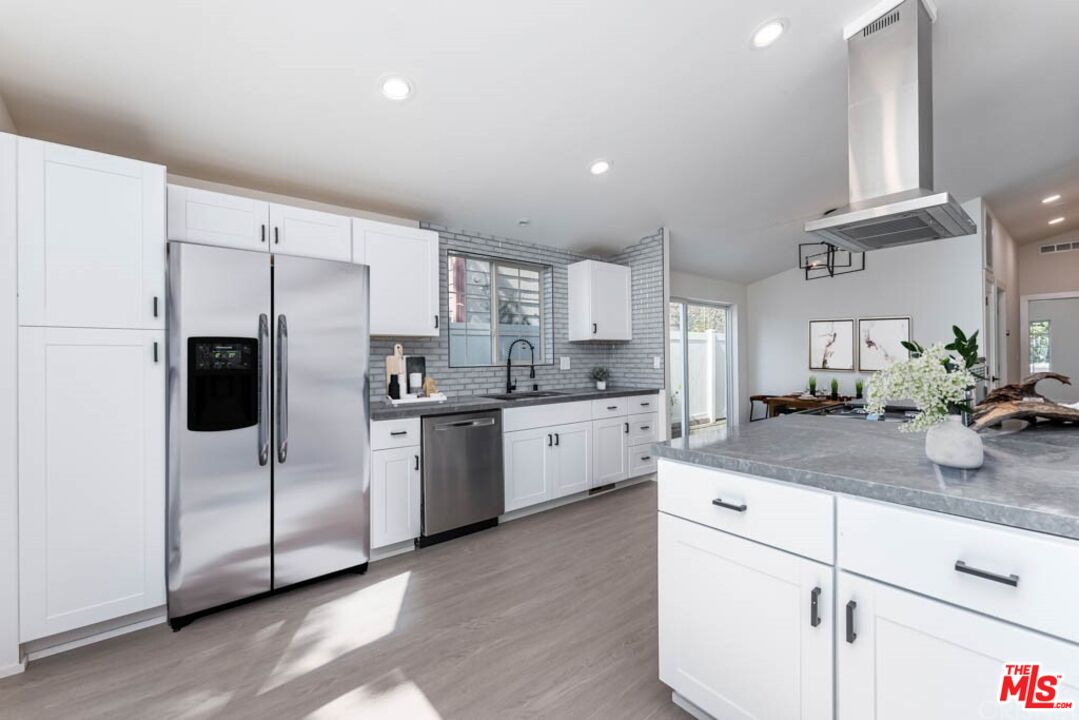 1177 Aztec Topanga, CA 90290 - Photo 8 of 43 a kitchen with white cabinets and white appliances