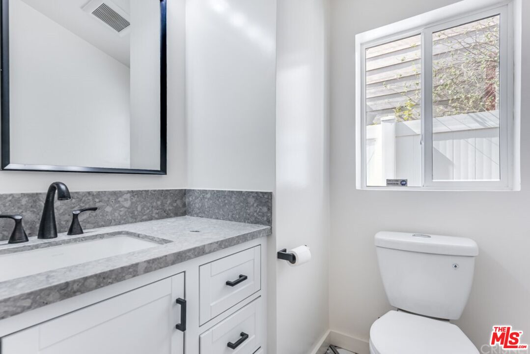 1177 Aztec Topanga, CA 90290 - Photo 10 of 43 a bathroom with a granite countertop toilet sink and mirror