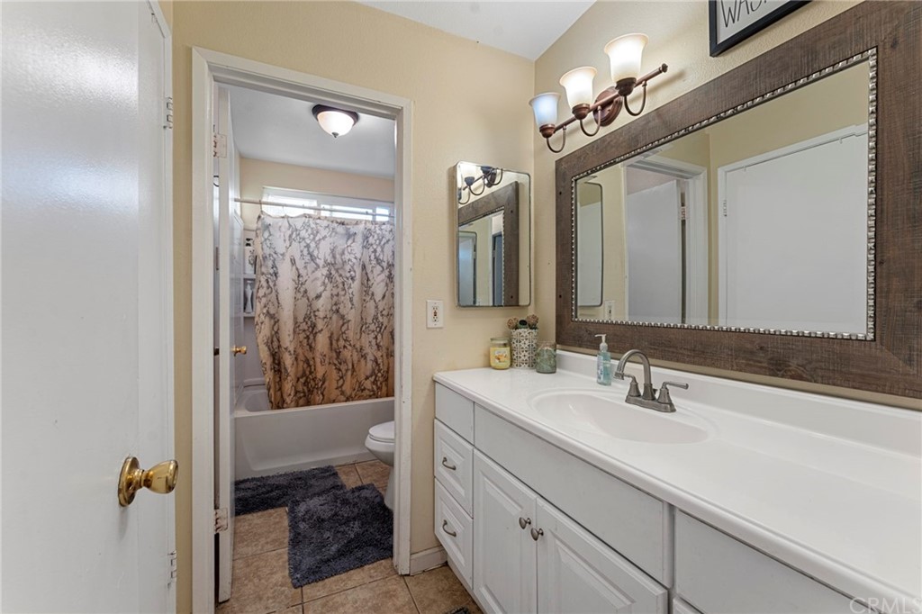 5005 Pearblossom Drive Riverside, CA 92507 - Photo 11 of 19 a en suite bathroom with a double vanity sink a mirror and a shower