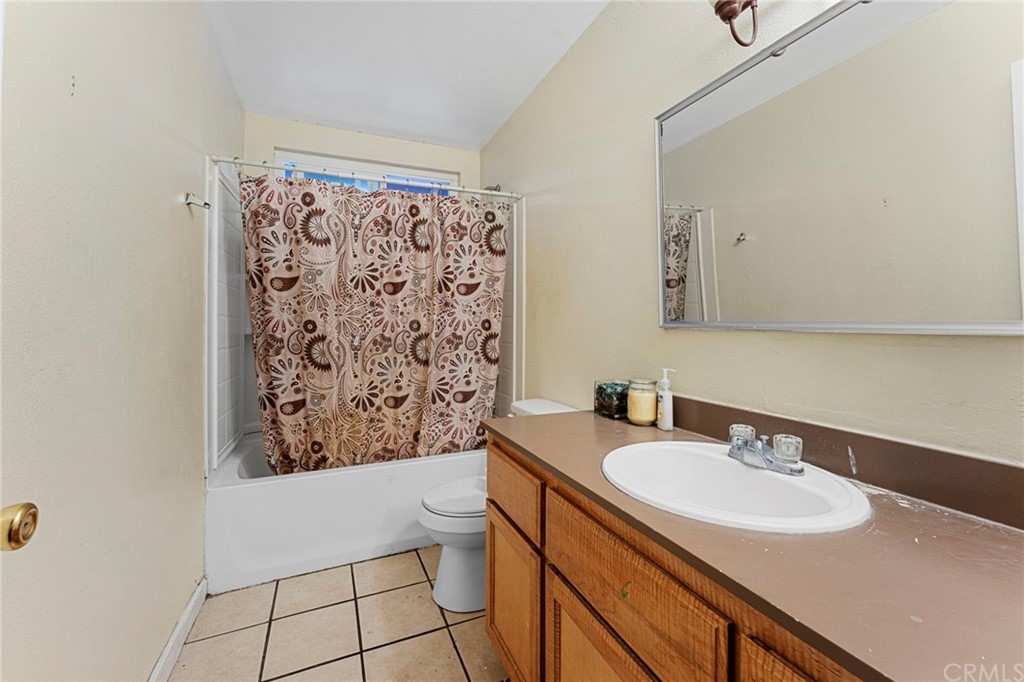 5005 Pearblossom Drive Riverside, CA 92507 - Photo 13 of 19 a bathroom with a sink toilet and shower