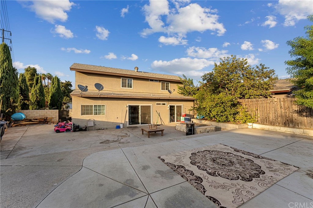 5005 Pearblossom Drive Riverside, CA 92507 - Photo 17 of 19 a view of a house with large space and a car parked beside it