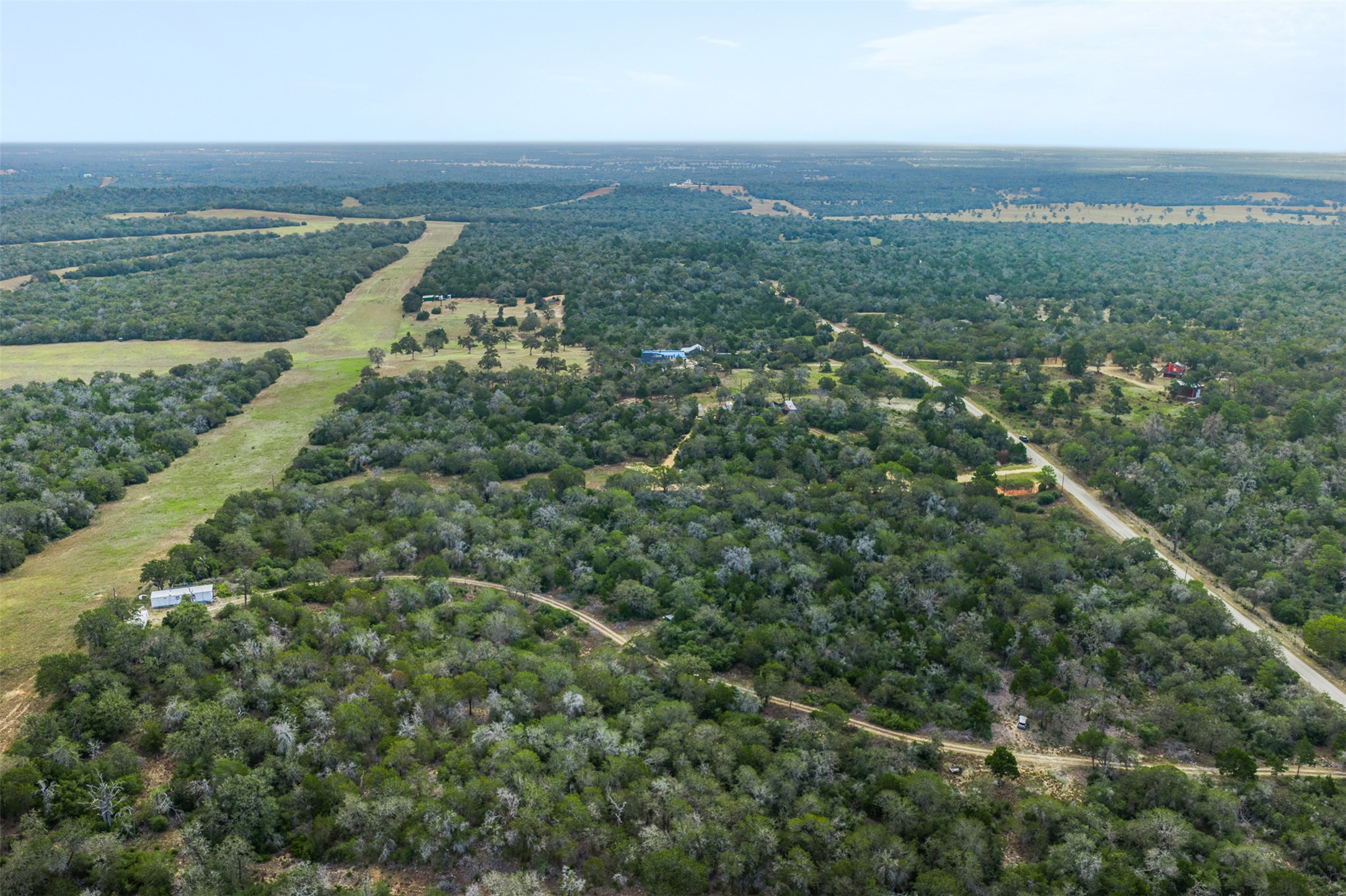 3301 Chuckwagon Road Harwood, TX 78632 - Photo 21 of 36 Lush woodlands and rolling green clearings define this vast countryside acreage.