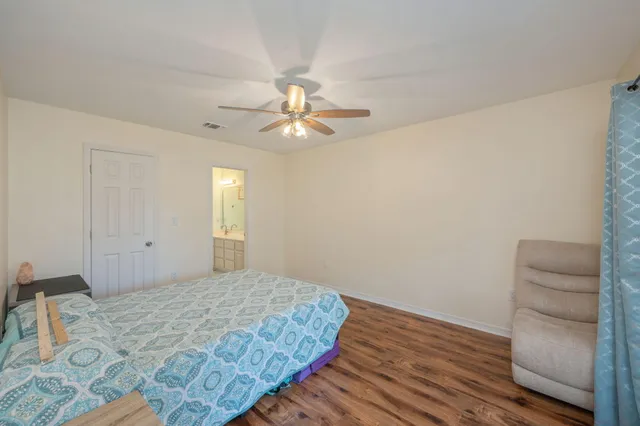 a bedroom with a bed and a ceiling fan