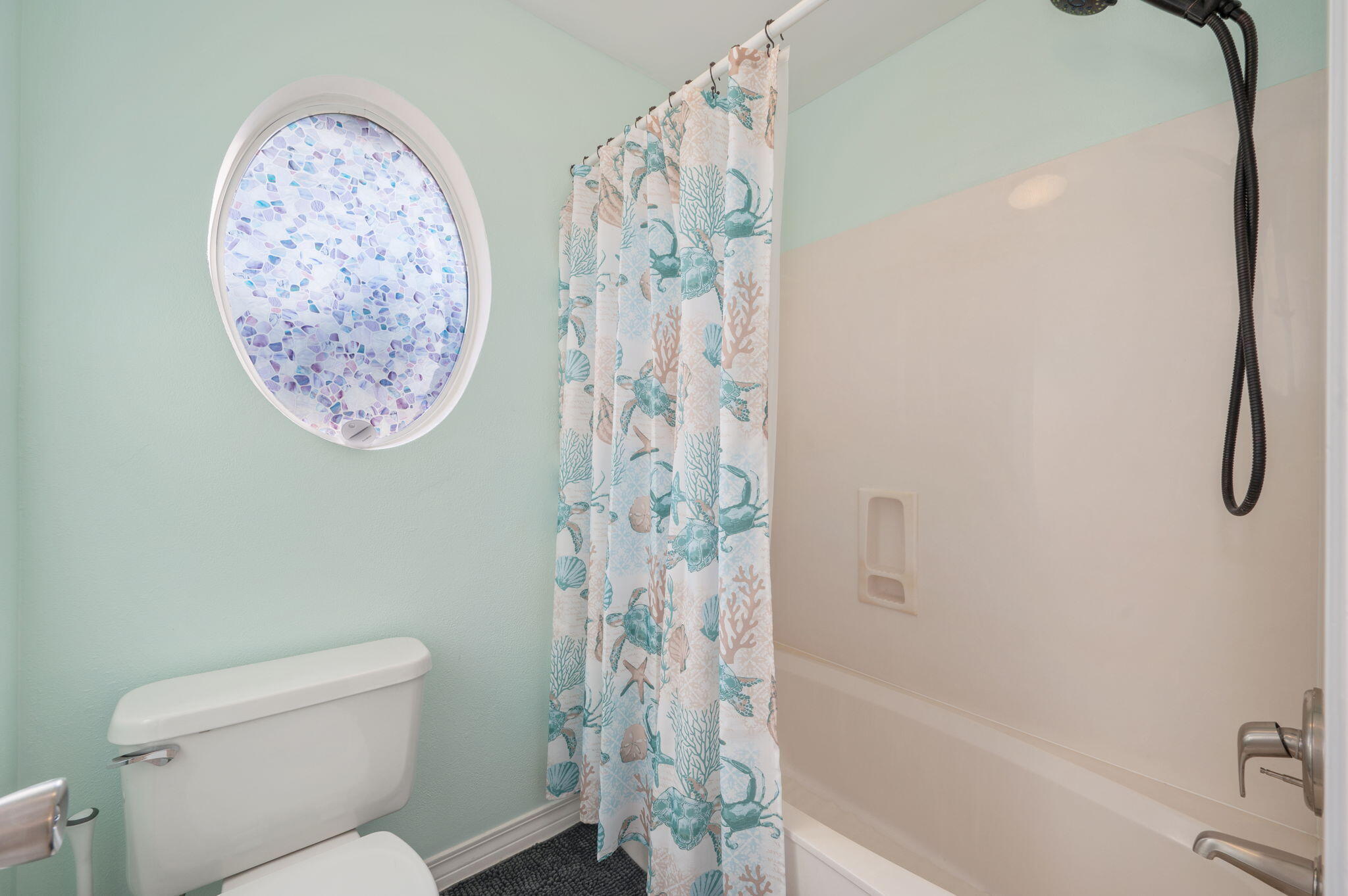 4654 Browning Court Crestview, FL 32539 - Photo 14 of 45 a bathroom with a toilet and a shower curtain