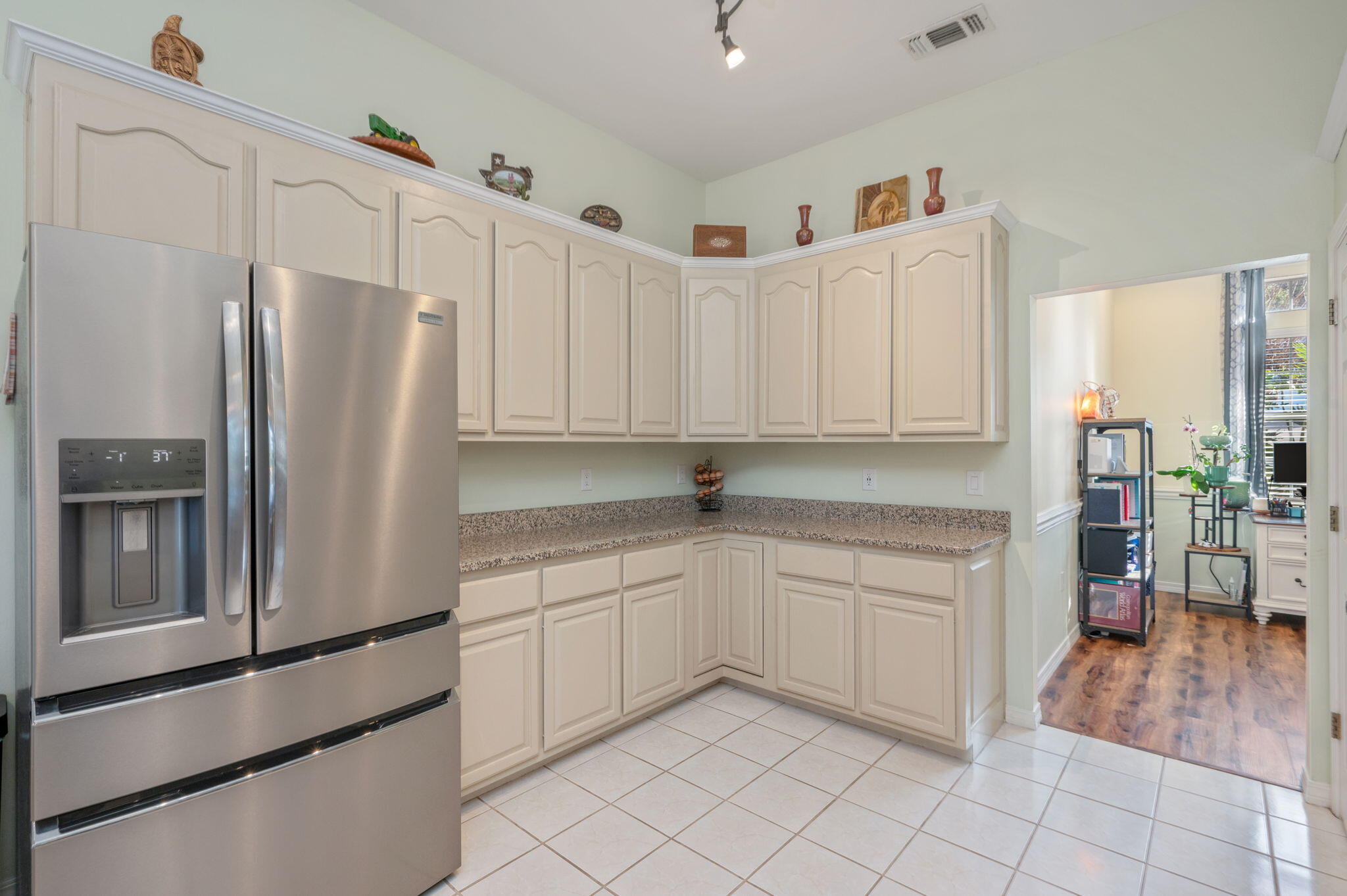 4654 Browning Court Crestview, FL 32539 - Photo 17 of 45 a kitchen with white cabinets and refrigerator
