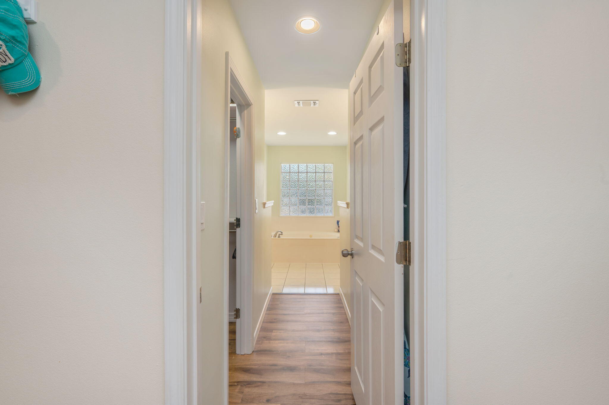 4654 Browning Court Crestview, FL 32539 - Photo 23 of 45 a view of a hallway with wooden floor and a bathroom