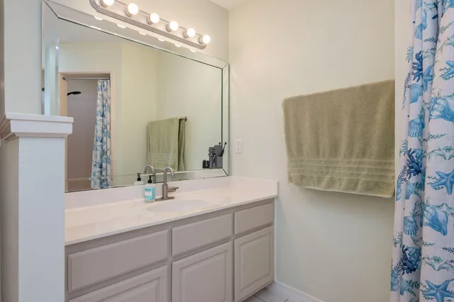 a bathroom with a sink vanity and a mirror