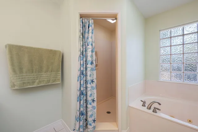 a bathroom with a bathtub and shower