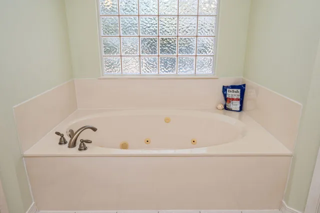a white bath tub sitting next to a window