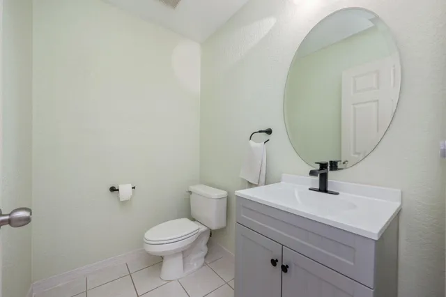 a bathroom with a toilet a sink and mirror