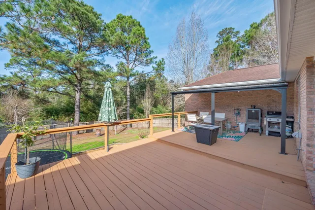 a view of a patio with chairs and potted plants