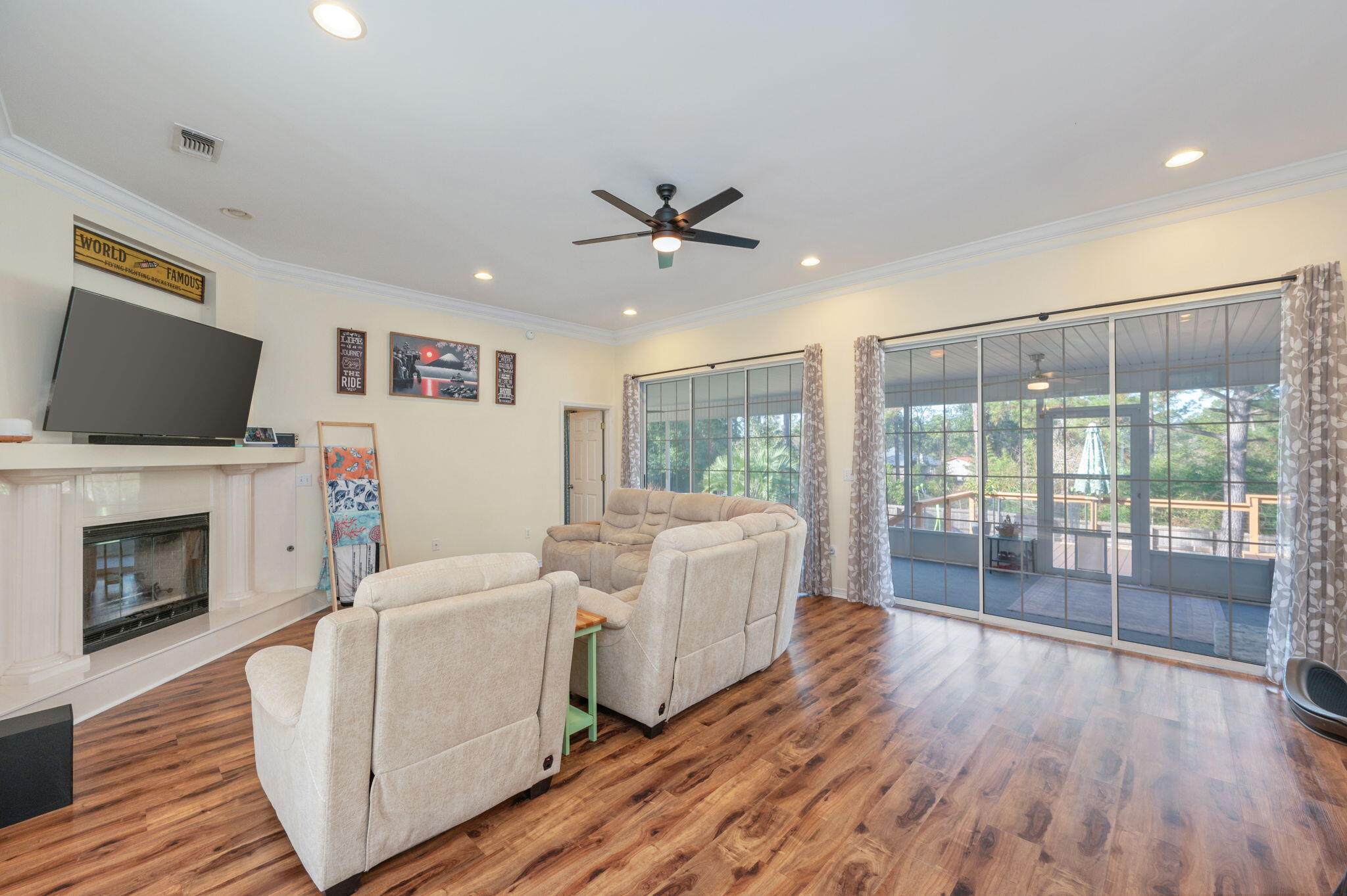 4654 Browning Court Crestview, FL 32539 - Photo 6 of 45 a living room with furniture a fireplace and a flat screen tv