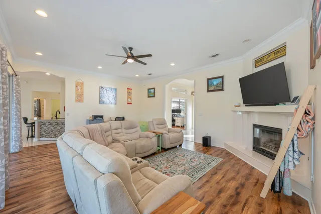 a living room with furniture a fireplace and a flat screen tv
