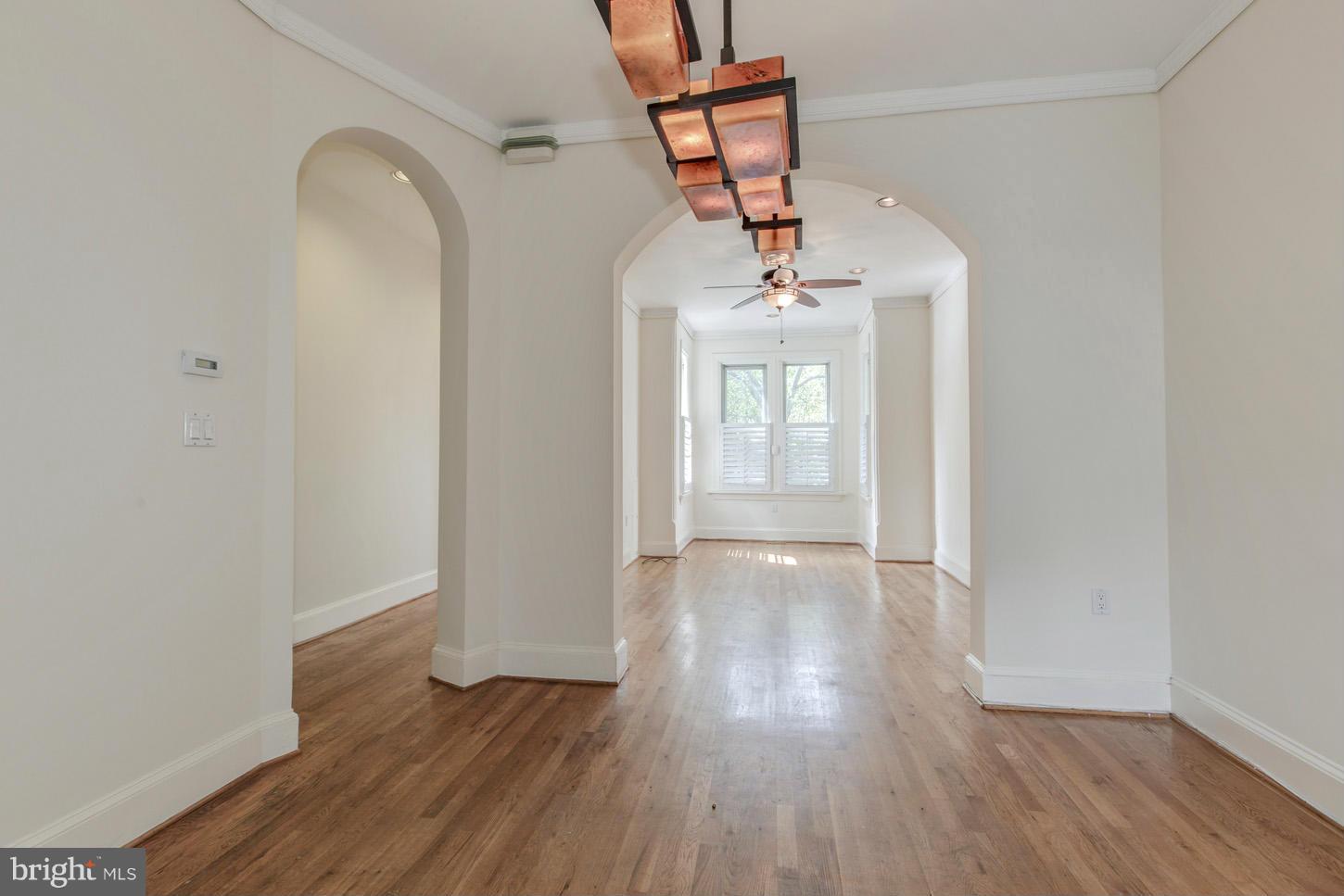 245 10th Street Northeast Washington, DC 20002 - Photo 8 of 17 a view of a room with wooden floor and white walls