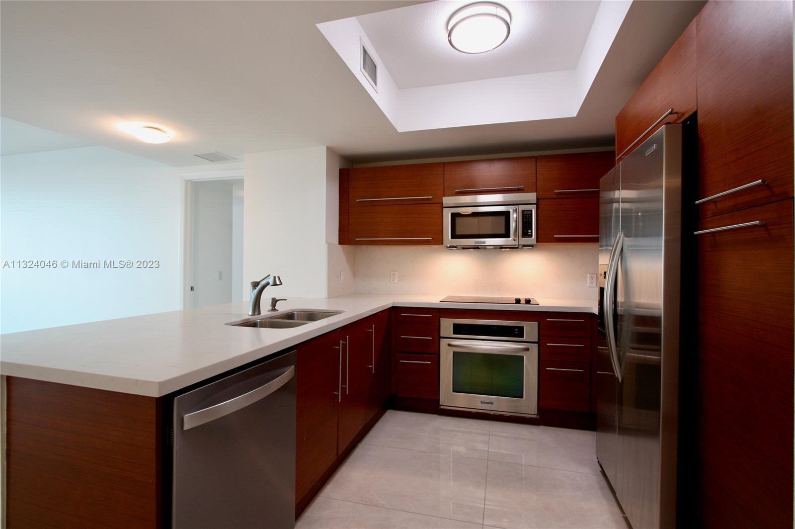 2681 North Flamingo Road, Unit 506S Sunrise, FL 33323 - Photo 1 of 20 a kitchen with stainless steel appliances granite countertop a sink stove and refrigerator