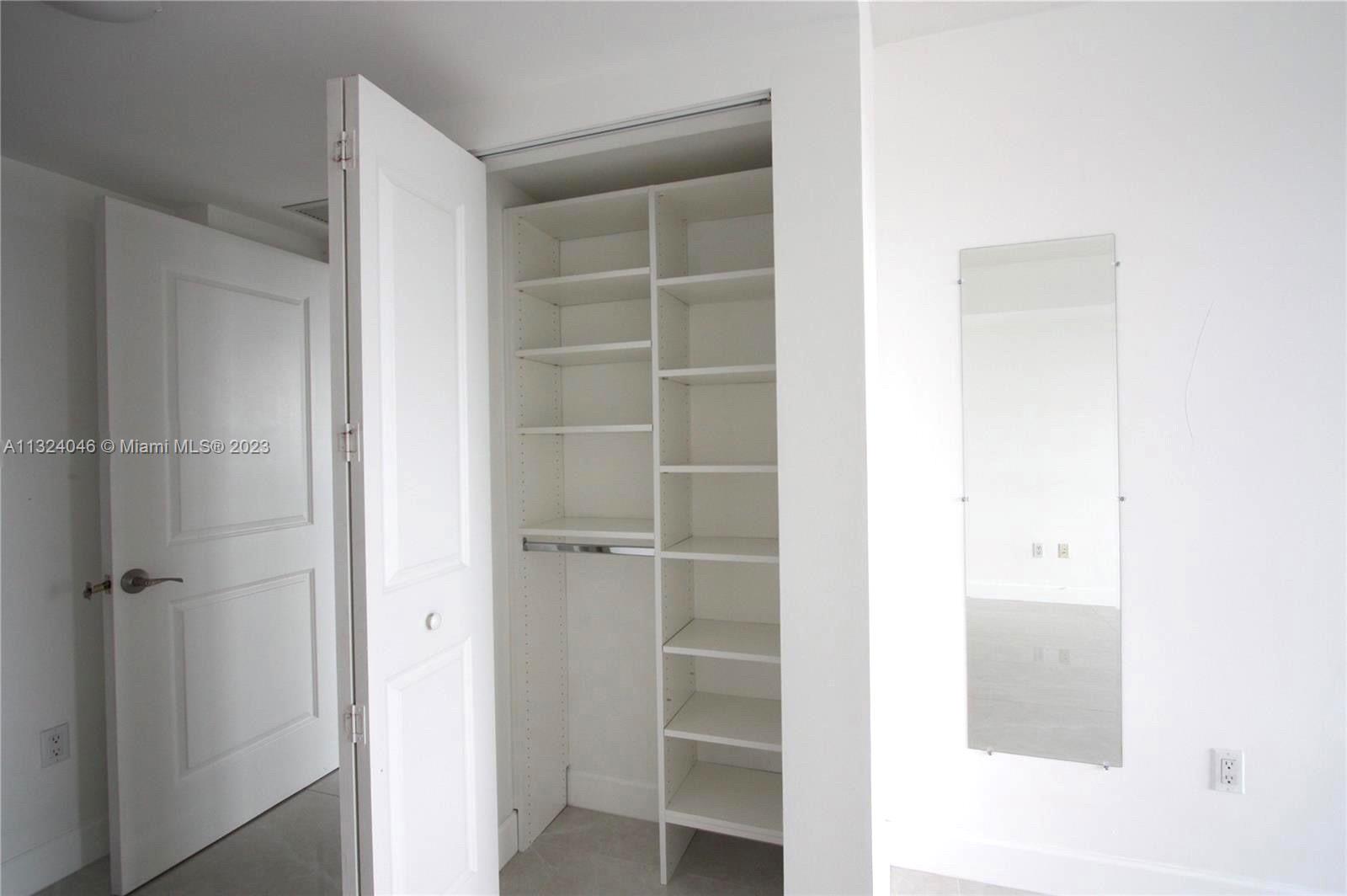 2681 North Flamingo Road, Unit 506S Sunrise, FL 33323 - Photo 13 of 20 a view of walk in closet with empty racks