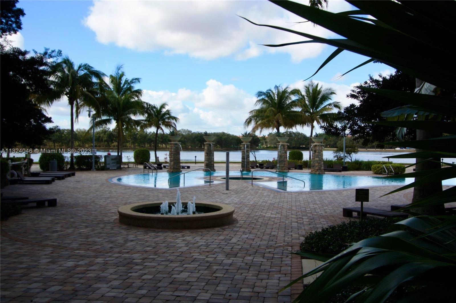 2681 North Flamingo Road, Unit 506S Sunrise, FL 33323 - Photo 19 of 20 a view of a swimming pool with a table and chairs