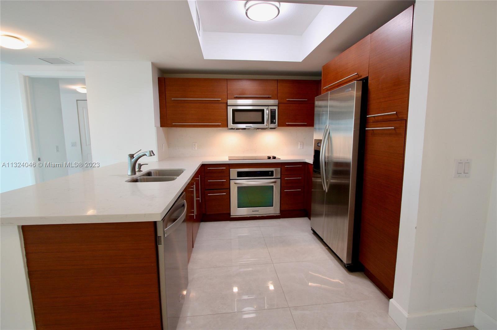 2681 North Flamingo Road, Unit 506S Sunrise, FL 33323 - Photo 2 of 20 a kitchen with stainless steel appliances a sink and a refrigerator