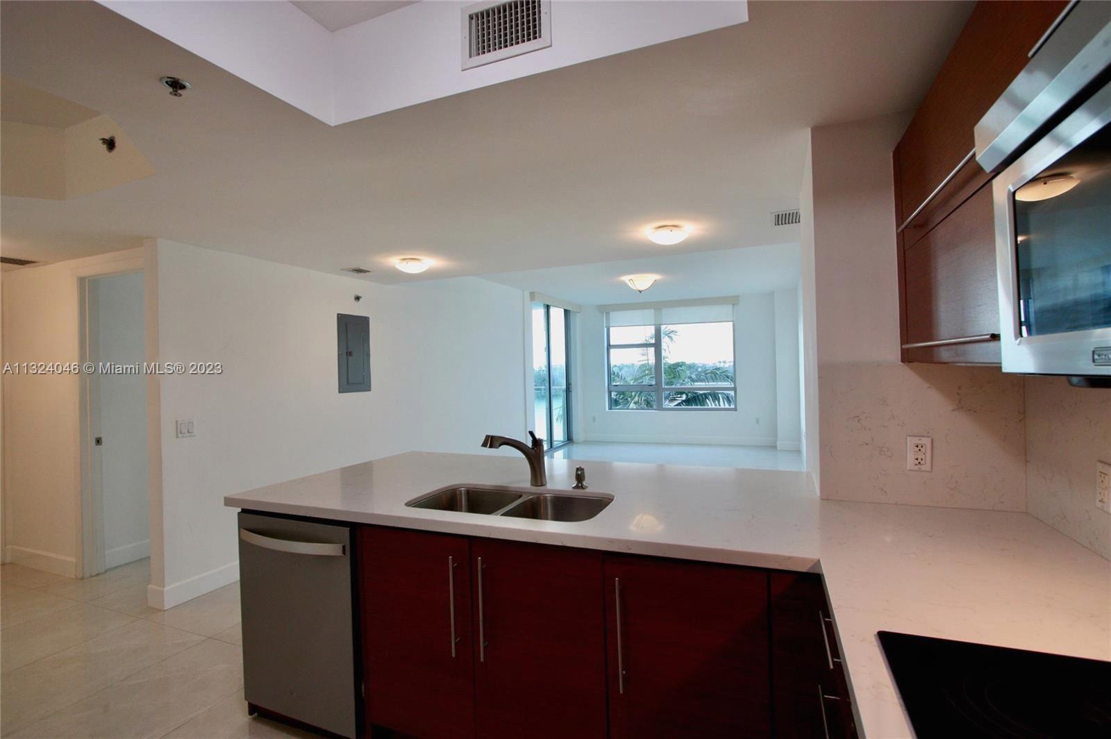 2681 North Flamingo Road, Unit 506S Sunrise, FL 33323 - Photo 3 of 20 a kitchen with stainless steel appliances a sink and a refrigerator