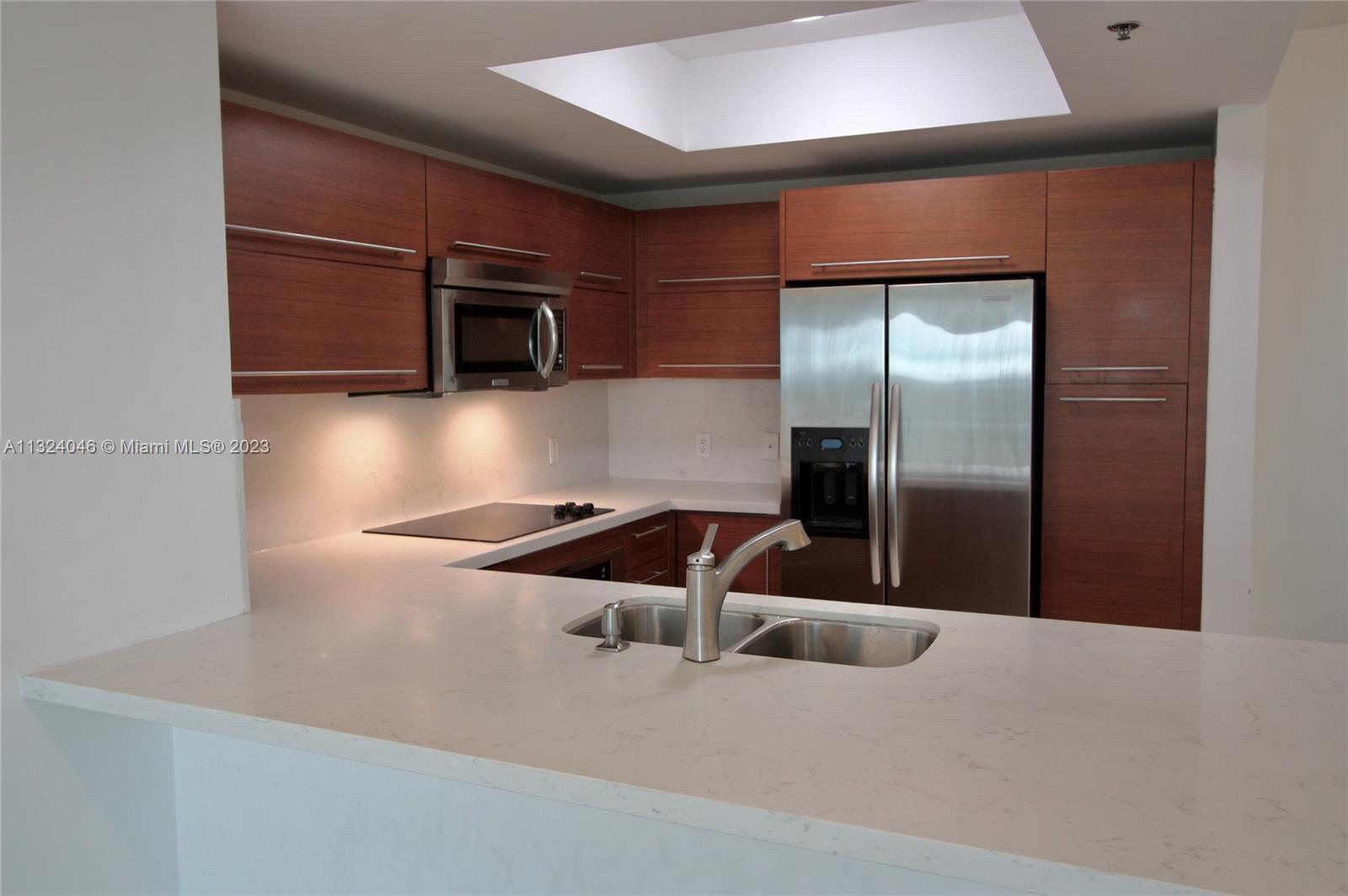 2681 North Flamingo Road, Unit 506S Sunrise, FL 33323 - Photo 4 of 20 a kitchen with stainless steel appliances granite countertop a refrigerator and a microwave