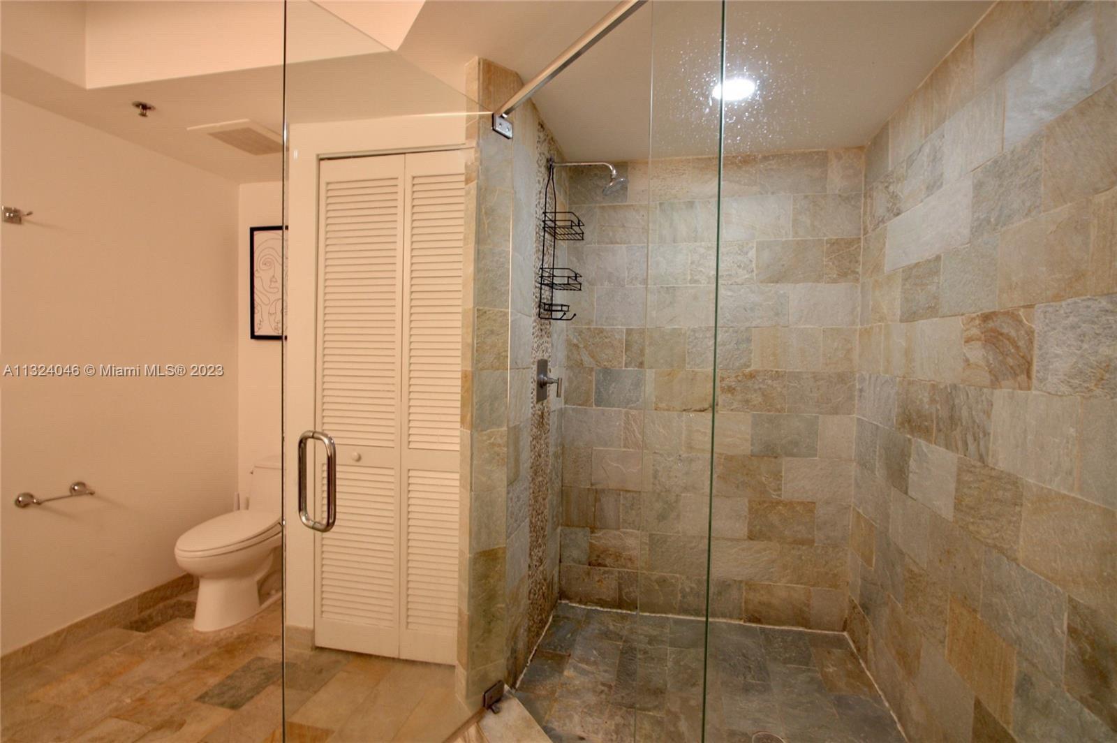 2681 North Flamingo Road, Unit 506S Sunrise, FL 33323 - Photo 9 of 20 a bathroom with a shower and a toilet
