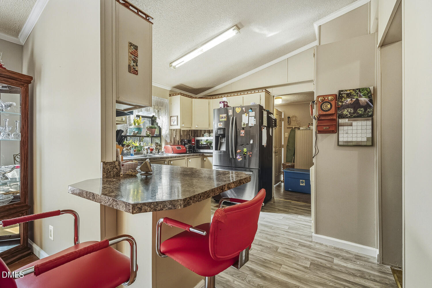3663 Chewning Road Oxford, NC 27565 - Photo 18 of 43 a kitchen with stainless steel appliances granite countertop a sink refrigerator and cabinets