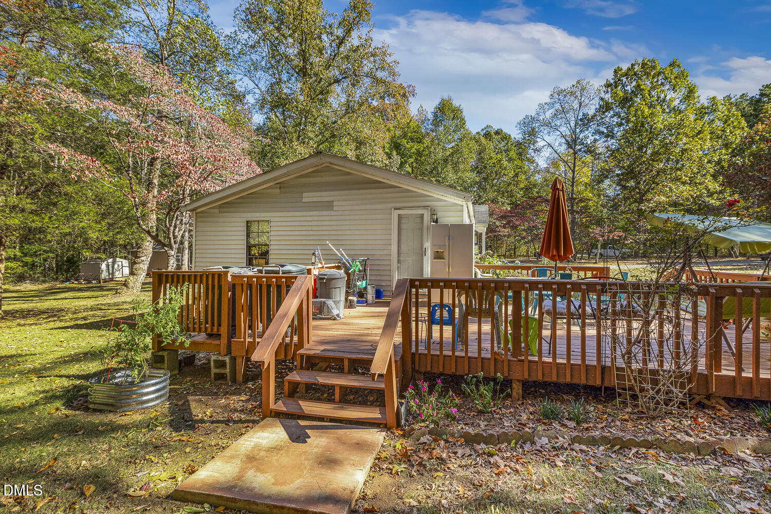 3663 Chewning Road Oxford, NC 27565 - Photo 30 of 43 a view of a deck with a table chairs and a yard